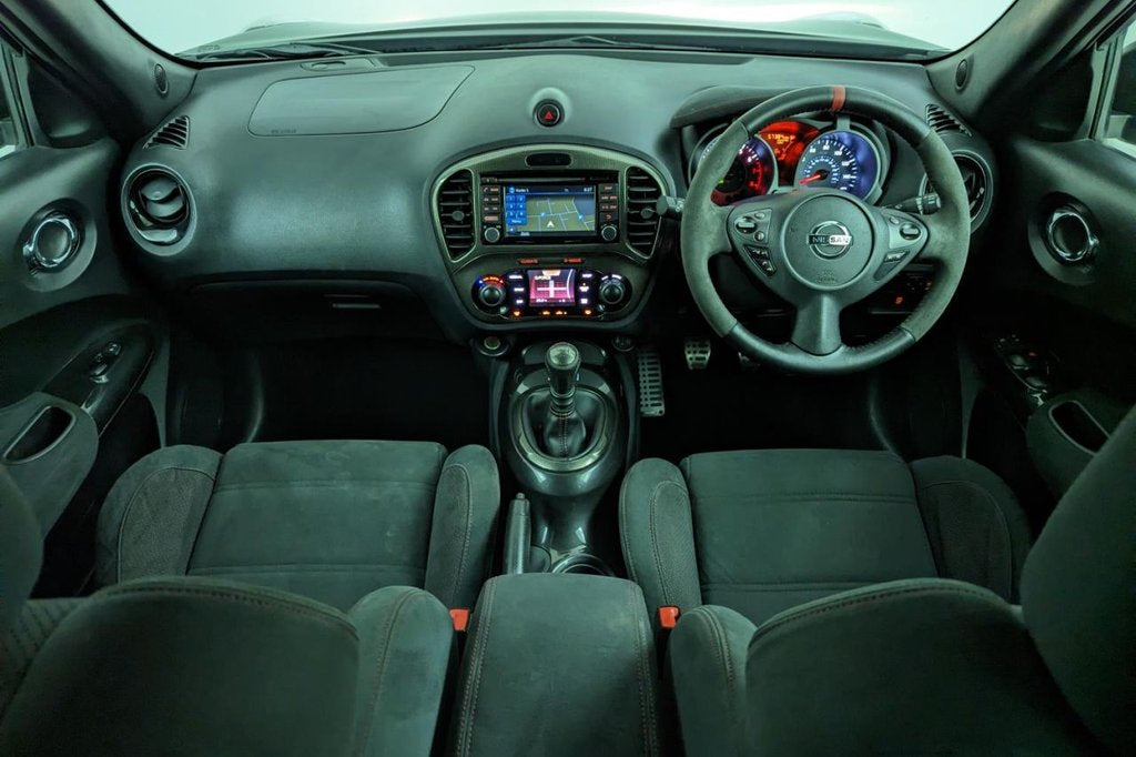 Car interior with dashboard, steering wheel, and seats.