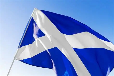 Blue and white Scotland flag waving against a clear blue sky